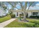 Inviting front yard featuring lush landscaping and a charming walkway leading to the front door with flower pots at 301 Andover S Pl # 185, Sun City Center, FL 33573