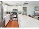 Bright kitchen features white cabinets, stainless steel appliances, and stylish backsplash at 301 Andover S Pl # 185, Sun City Center, FL 33573