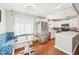 Charming eat-in kitchen featuring white cabinets, stainless steel appliances, and a cozy breakfast nook with built-in seating at 301 Andover S Pl # 185, Sun City Center, FL 33573