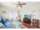 Inviting living room with a plush blue sofa, stylish ottoman, and modern entertainment center at 301 Andover S Pl # 185, Sun City Center, FL 33573