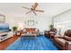 Inviting living area boasting hardwood floors, a comfortable sofa, and a large screen TV for entertainment, creating a relaxing ambiance at 301 Andover S Pl # 185, Sun City Center, FL 33573