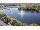 Scenic view of the pond with a fountain surrounded by grass, trees, and homes at 301 Andover S Pl # 185, Sun City Center, FL 33573