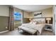 Main bedroom with a bench at the foot of the bed at 31277 Midnight Sun Way, Wesley Chapel, FL 33545