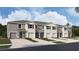 New townhome community with 4-unit buildings, 2-car garages, and landscaped yards at 31277 Midnight Sun Way, Wesley Chapel, FL 33545