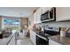 Modern kitchen with stainless steel appliances and view of living area at 31277 Midnight Sun Way, Wesley Chapel, FL 33545