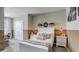 Charming bedroom with a white bed frame and striped wall accents at 31279 Midnight Sun Way, Wesley Chapel, FL 33545