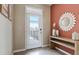 Bright entryway with decorative mirror and console table at 31279 Midnight Sun Way, Wesley Chapel, FL 33545