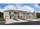 New townhome community with attached garages and landscaping at 31279 Midnight Sun Way, Wesley Chapel, FL 33545