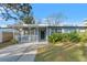 Charming light blue house with white trim, a covered porch, and a well-manicured lawn at 345 Dr Ml King Jr N St, Safety Harbor, FL 34695