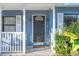Dark brown front door with a stained glass window and white trim at 345 Dr Ml King Jr N St, Safety Harbor, FL 34695
