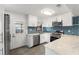 Modern kitchen with white cabinets, stainless steel appliances, and blue tile backsplash at 345 Dr Ml King Jr N St, Safety Harbor, FL 34695