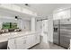 Modern kitchen with white cabinets, stainless steel appliances, and blue tile backsplash at 345 Dr Ml King Jr N St, Safety Harbor, FL 34695