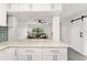 Modern kitchen with white cabinets, stainless steel appliances, and blue tile backsplash at 345 Dr Ml King Jr N St, Safety Harbor, FL 34695