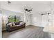 Living room with gray sofa, wood-look floors, and a view of the kitchen at 345 Dr Ml King Jr N St, Safety Harbor, FL 34695