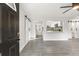 Open living room and kitchen area with modern flooring and barn doors at 345 Dr Ml King Jr N St, Safety Harbor, FL 34695