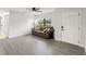 Living room with gray sofa, wood-look floors, and a view of the front door at 345 Dr Ml King Jr N St, Safety Harbor, FL 34695