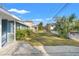 Side yard view showing the home's light blue exterior and a grassy area at 345 Dr Ml King Jr N St, Safety Harbor, FL 34695