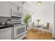 Bright kitchen nook with white cabinetry and eat-in dining area at 3645 5Th S Ave, St Petersburg, FL 33711