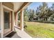 A covered back porch with a view of the grassy backyard at 3900 Claybrook Dr, Wesley Chapel, FL 33544