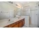 This bathroom features a double sink vanity with a glass-enclosed shower and great lighting at 3900 Claybrook Dr, Wesley Chapel, FL 33544