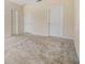 An empty room with three doors and light carpet at 3900 Claybrook Dr, Wesley Chapel, FL 33544