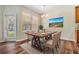 A dining room featuring a wooden table, seating for six, and a large window for natural light at 3900 Claybrook Dr, Wesley Chapel, FL 33544