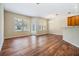 Open concept dining area with hardwood floors, a modern light fixture and large windows at 3900 Claybrook Dr, Wesley Chapel, FL 33544