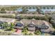 Scenic aerial view of townhomes with well-maintained landscaping and a serene lake backdrop at 3900 Claybrook Dr, Wesley Chapel, FL 33544