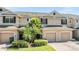 Inviting two-story home features a two-car garage, mature landscaping, and a brick driveway at 3900 Claybrook Dr, Wesley Chapel, FL 33544