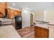 Open kitchen featuring wood cabinets, modern appliances, and laminate floors at 3900 Claybrook Dr, Wesley Chapel, FL 33544