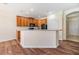 Open kitchen featuring wood cabinets, modern appliances, and a breakfast bar at 3900 Claybrook Dr, Wesley Chapel, FL 33544