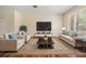 A spacious living room with comfortable seating, a stylish rug, and a large window at 3900 Claybrook Dr, Wesley Chapel, FL 33544