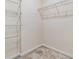 An ample walk-in closet with metal shelving and neutral walls offers great storage at 3900 Claybrook Dr, Wesley Chapel, FL 33544