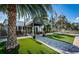 Ardea Country Club entrance and awning, with landscaping, flowers, and flagpoles at 4754 Stoneview Cir, Oldsmar, FL 34677