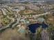 Aerial view of the community's pool, tennis courts, basketball courts, and pond at 4927 Rolling Green Dr, Wesley Chapel, FL 33543