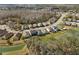 A neighborhood aerial view with a pond in the backyard at 4927 Rolling Green Dr, Wesley Chapel, FL 33543