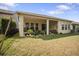 A spacious backyard with a covered patio and lush green grass at 4927 Rolling Green Dr, Wesley Chapel, FL 33543