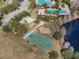 Aerial view of the community basketball court and playground near a lake at 4927 Rolling Green Dr, Wesley Chapel, FL 33543