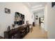 Hallway with wood-look tile flooring, natural light, decor, and entry to the backyard at 4927 Rolling Green Dr, Wesley Chapel, FL 33543
