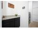 Bright laundry room with granite countertop and access to washer and dryer at 4927 Rolling Green Dr, Wesley Chapel, FL 33543