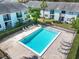 Community pool with brick pavers and lounge chairs for residents and guests at 5055 Terrace Club Ln # 202, Tampa, FL 33617