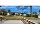Single story home with water access and a wooden footbridge at 5253 Dover Ne St, St Petersburg, FL 33703