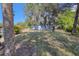 Large backyard with mature trees and grassy area at 6119 Beacon Point Dr, Weeki Wachee, FL 34607