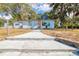 Light blue house with walkway and fenced yard at 6119 Beacon Point Dr, Weeki Wachee, FL 34607