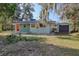 Rear view of the house showing additional storage and backyard at 6119 Beacon Point Dr, Weeki Wachee, FL 34607