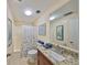 Clean bathroom with granite countertop, shower/tub combo and tiled floor at 7694 Eaton Ct, St Petersburg, FL 33709