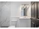 Modern bathroom with marble-tiled walls and hexagon floor tiles at 8737 Bay Pointe Dr, Tampa, FL 33615