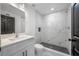 Modern bathroom with a large marble shower and white vanity at 8737 Bay Pointe Dr, Tampa, FL 33615