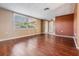 Bright living room with wood floors and ample natural light from the large window at 8922 Catalina Dr, Port Richey, FL 34668