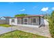 Home exterior featuring a screened-in porch, paver patio, and a fenced backyard at 9204 Wood Lake Blvd, Tampa, FL 33615